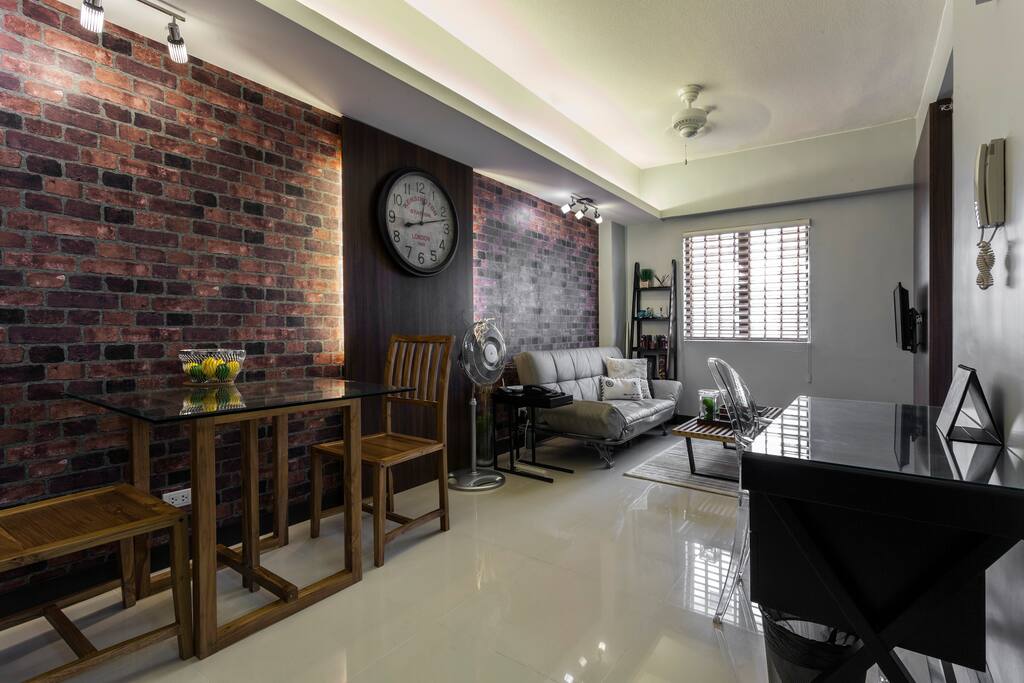 Everything you need is here: a working desk, cozy teak dinette, comfy living room with a sofa bed