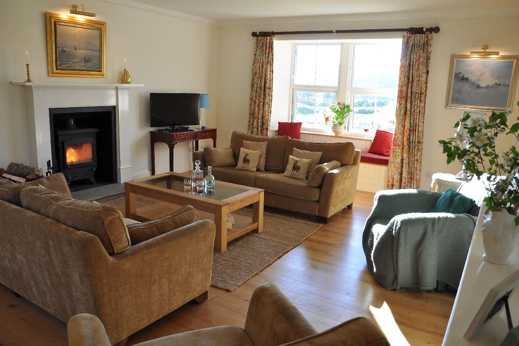 Large sitting room with log burner and smart TV.