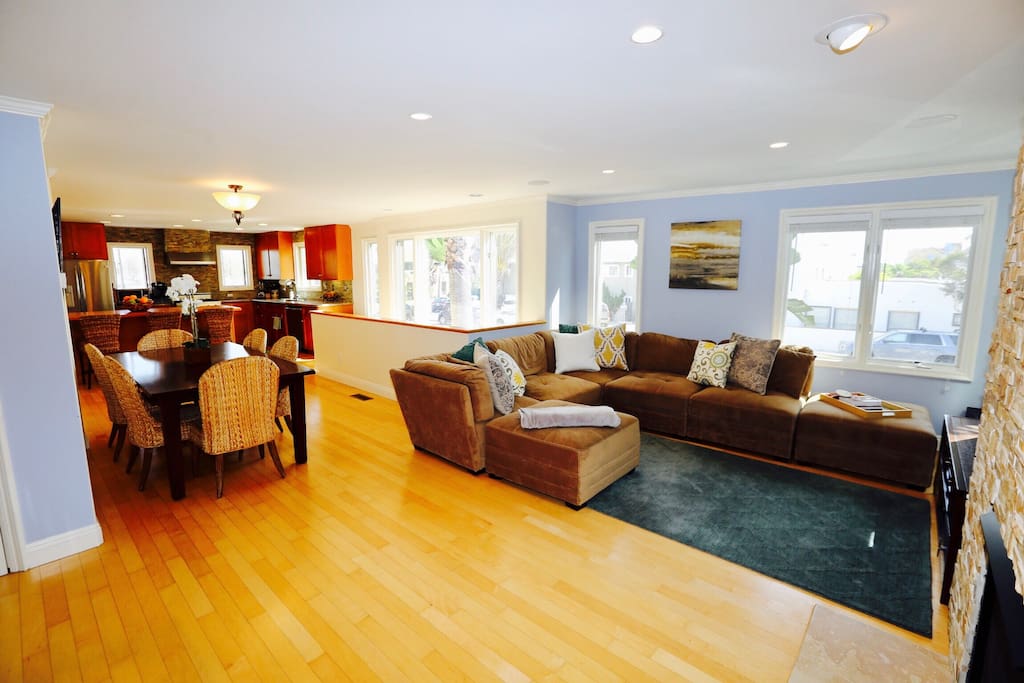 Living room with sectional couch, dining area and kitchen