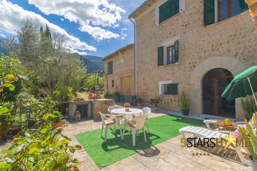 Terrace with dining table and sunbeds.