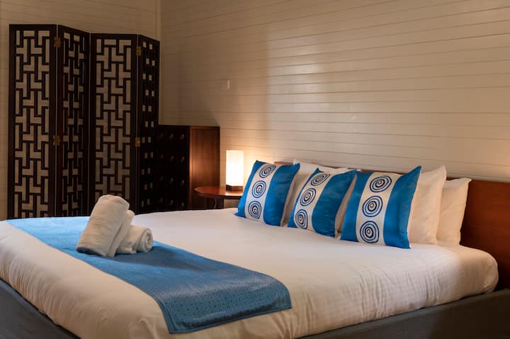 El dormitorio principal de Dantosa Cottage tiene una cama tamaño king y se abre a un pequeño patio. 