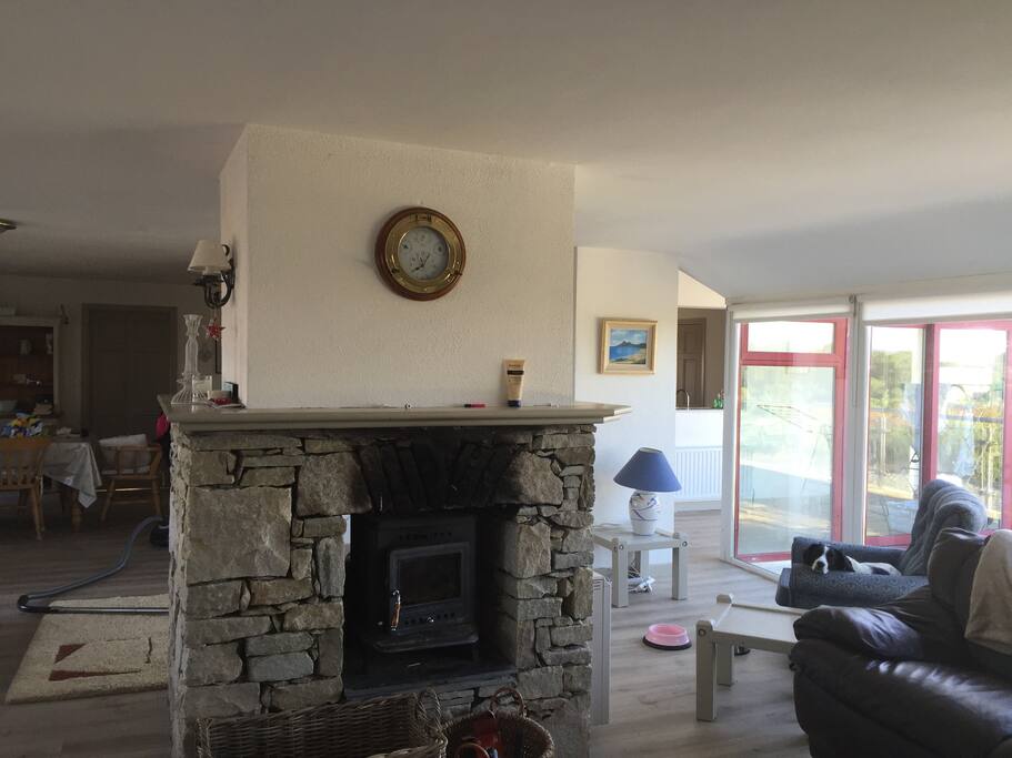 large open plan living dining area with stove and multi channel tv