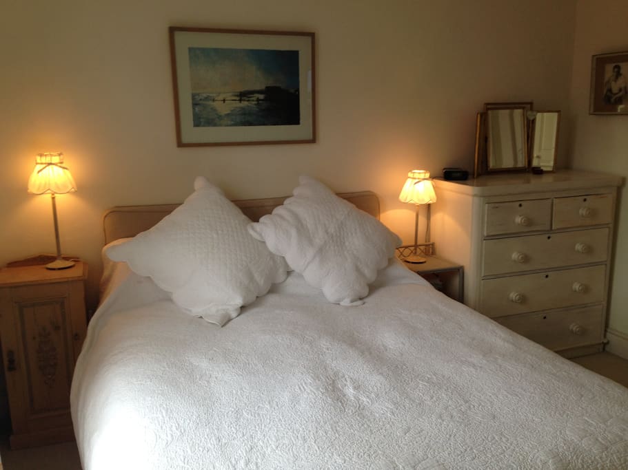 Brand new bed and matress with white cotton sheets.