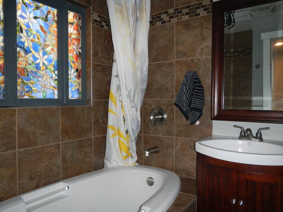 Private master bathroom with rain shower and jacuzzi tub are yours to enjoy