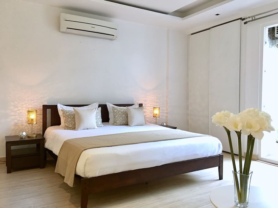 Bedroom 1: King size bed, large wardrobe, sitting area, en-suite bathroom and balcony overlooking a green park