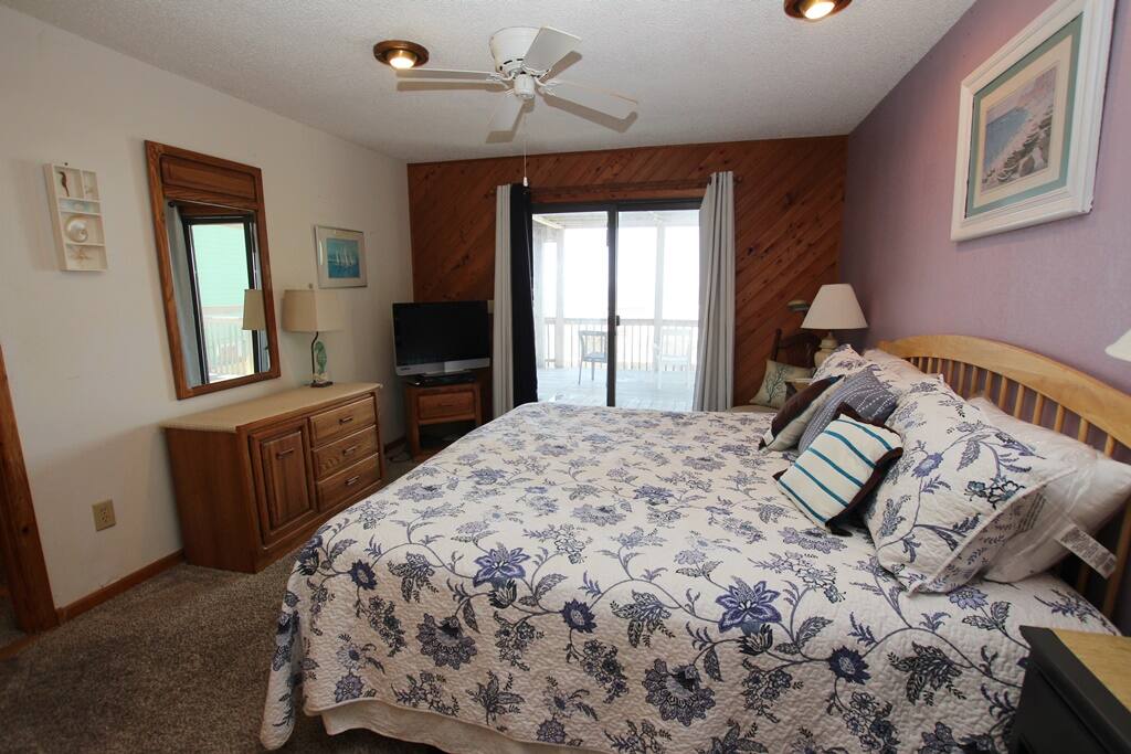 Interior view of room with beach view out of slider.