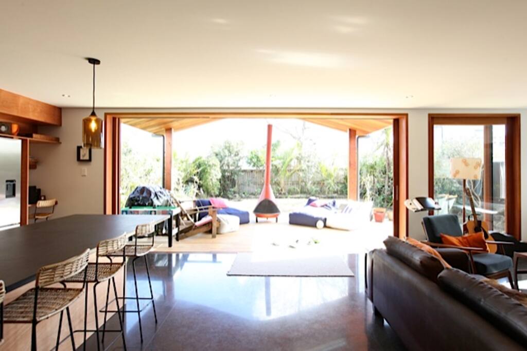 Open plan kitchen dining lounge opening on to large deck