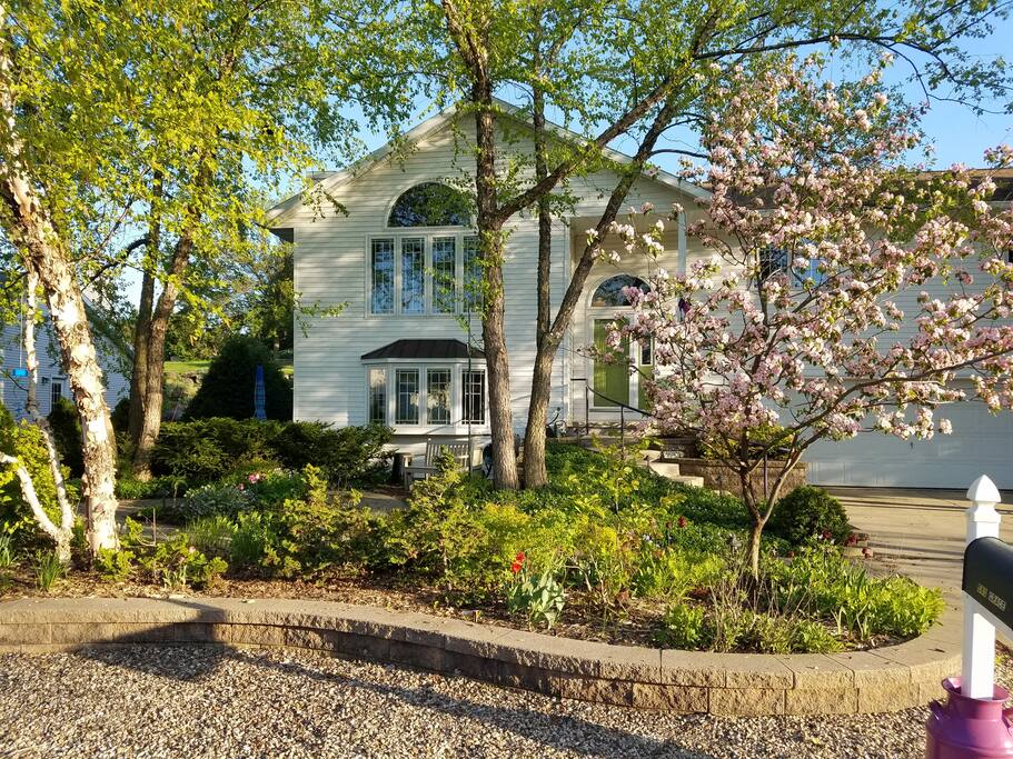 Our house in Spring. Your flat is on the first floor. Take the sidewalk from the driveway to the left side facing the house. Two entrances on the street level.