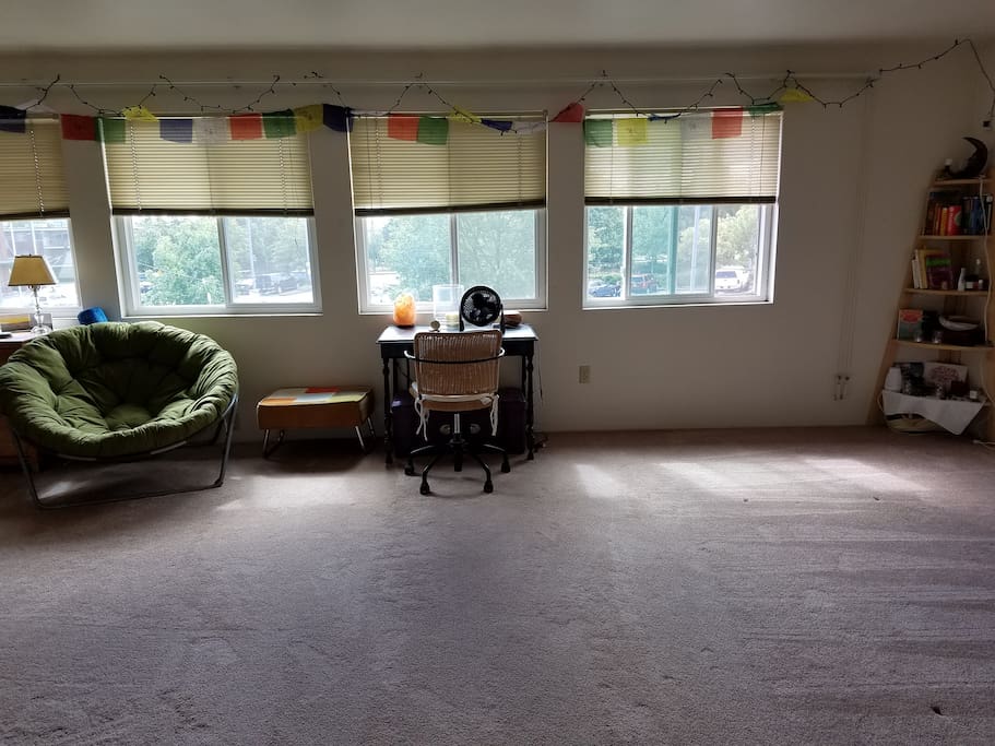 Living room with desk space and space for an air mattress to accommodate more guests.