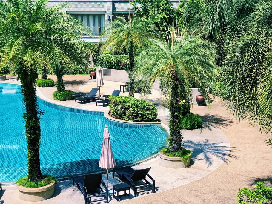 Spacious pool area in lush gardens a few steps from the beach
