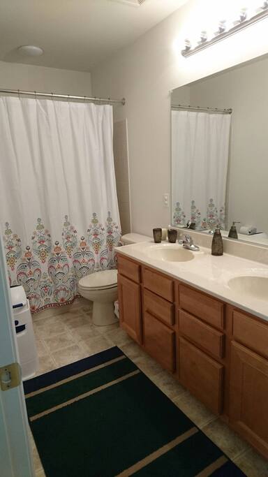 Bathroom with double sink and tub/shower.