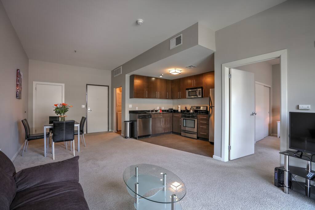 Lounging area with a view of the kitchen making it easy for people who like to cook communicate with those who don't!