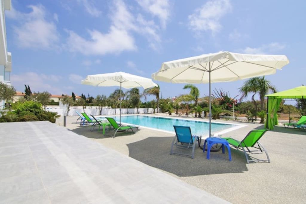 swimming pool with broadened space with sun beds, umbrellas and a kiosk!