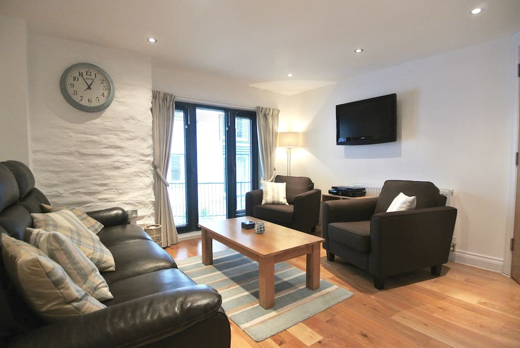 Floor to ceiling windows letting lots of natural light in together with gentle sea breeze. Quiet, private walkway to the outside. Reclining leather settee, two ample armchairs, TV and DVD.