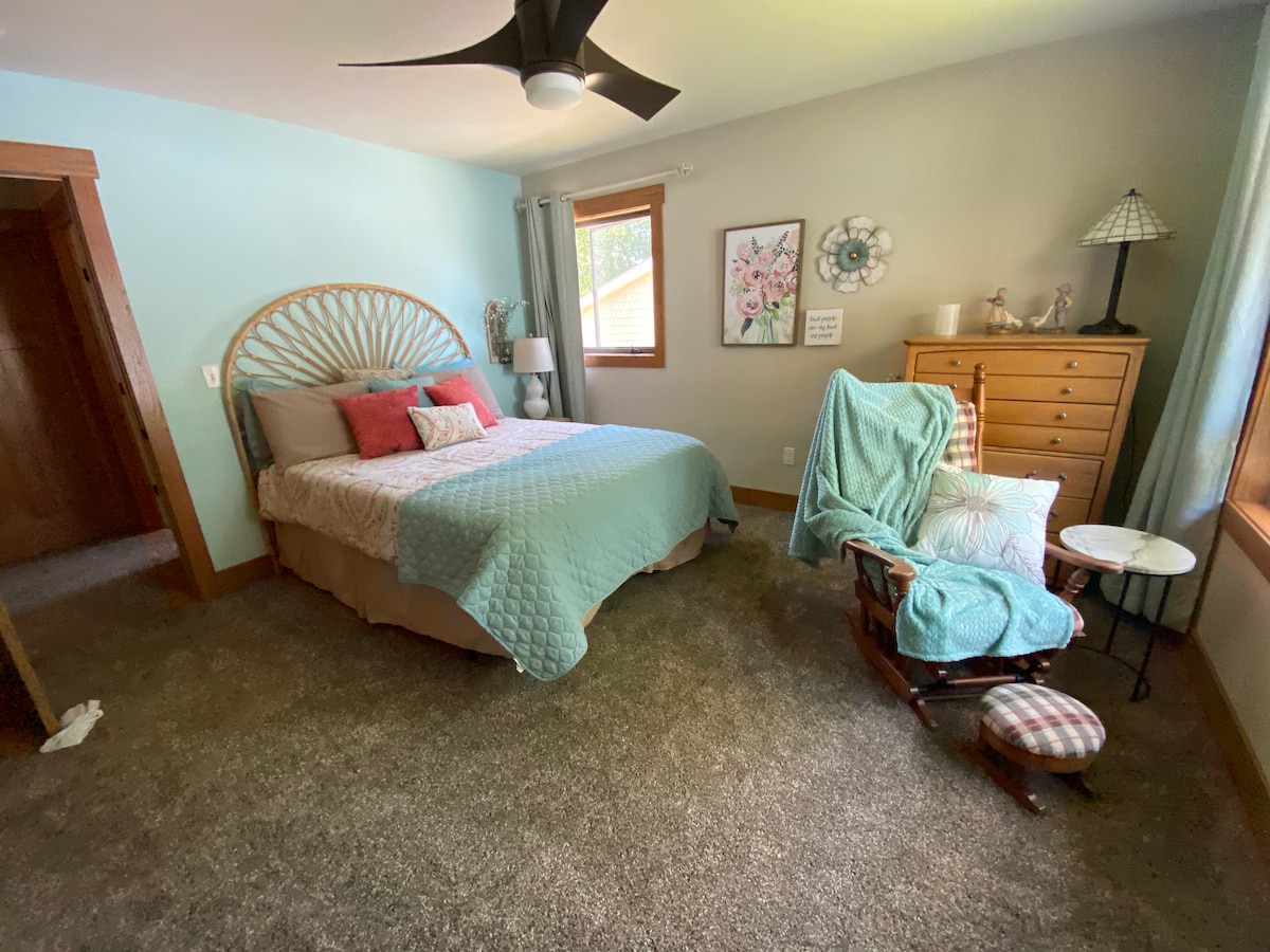 Queen bed next to bathroom on the second level. 2 closets and dresser for storage space.