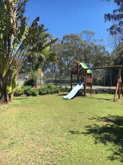 Tennis court, swings & slide