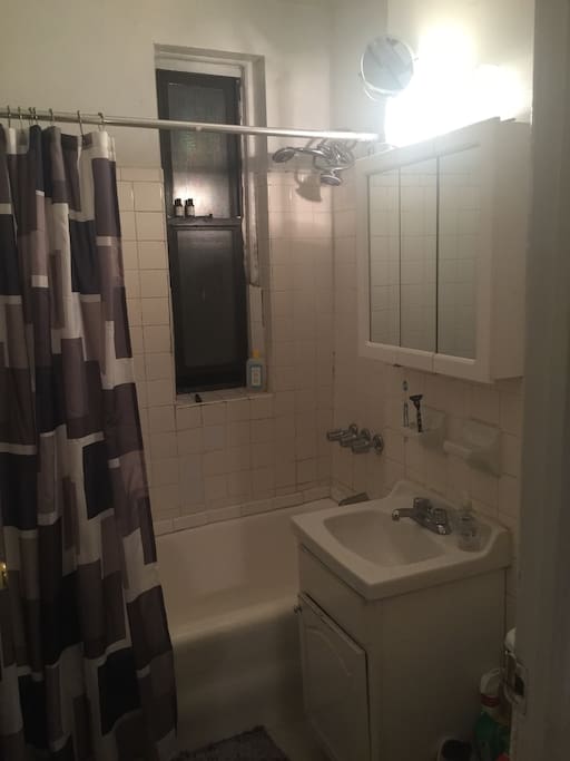 Bathroom tub, sink, cabinet and mirror