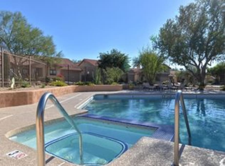 Community pool, hot tub and outdoor kitchen and lounge area steps from the house.