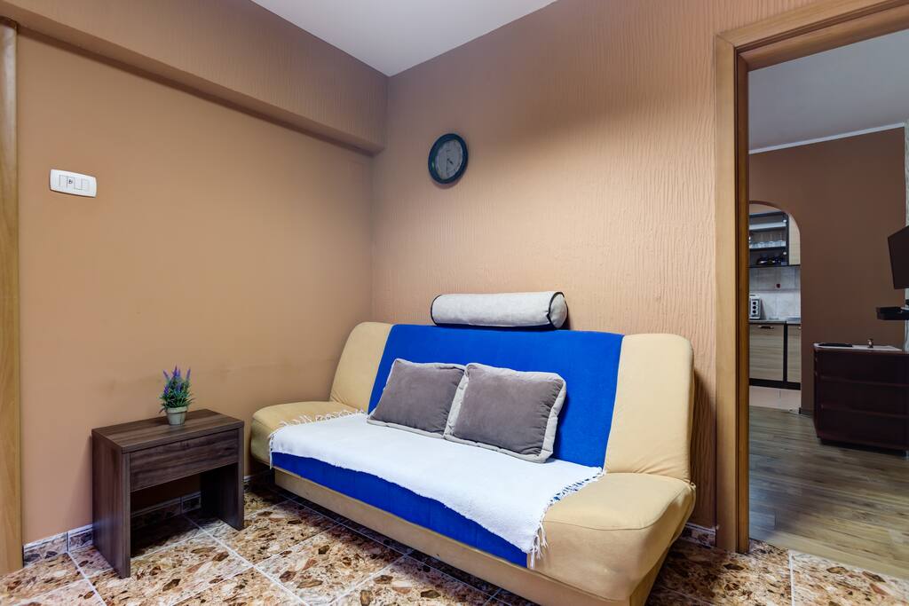On the entrance into the apartment, there is a comfortable sofa with coffee table. Warm tones in this corner will definitely create friendly atmosphere among our guests.