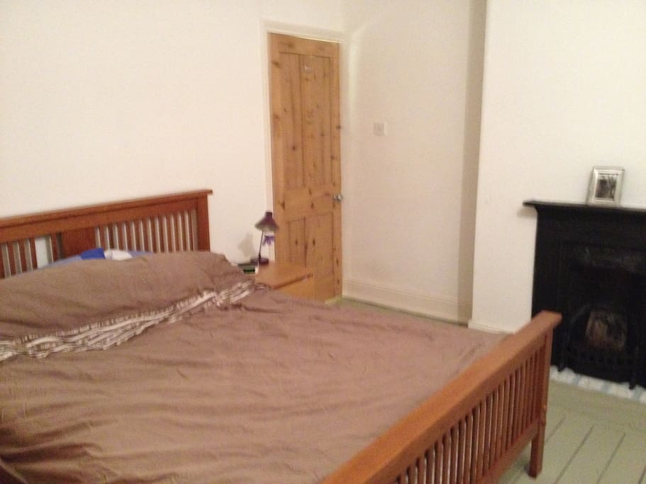 A spacious double bedroom with a king sized bed