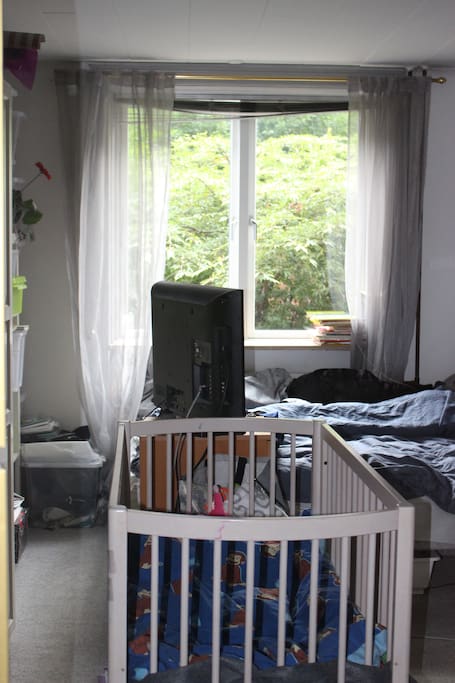 Bedroom with a cot and a changing table.