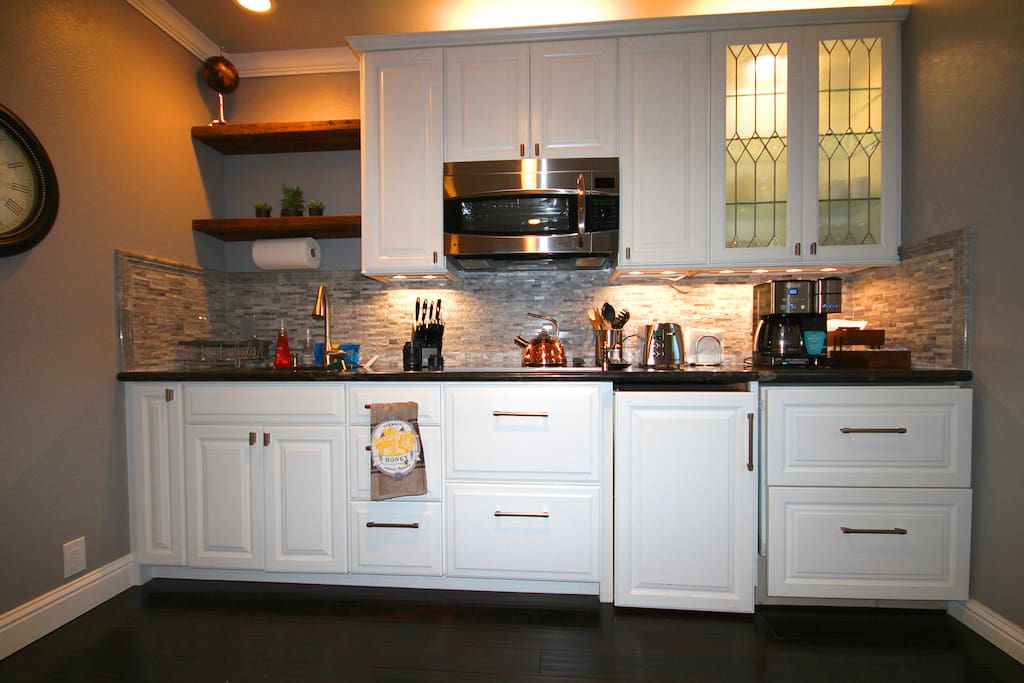 Full kitchen with electric range, microwave/convection oven, and under-counter fridge and freezer.