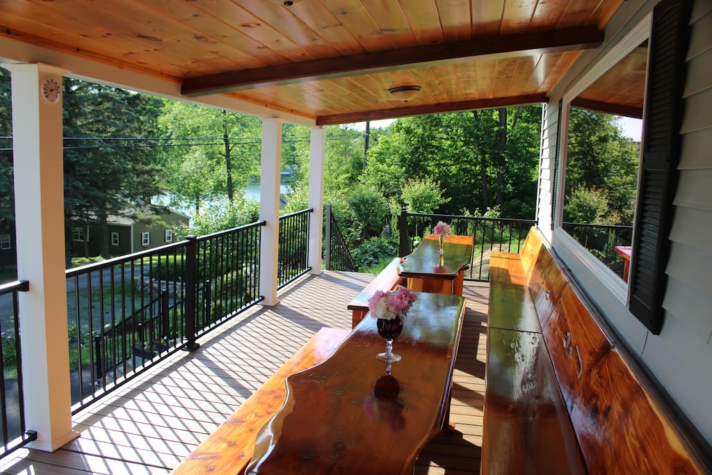 Red Ceder dinning area on cover deck of the house with view to the lake.