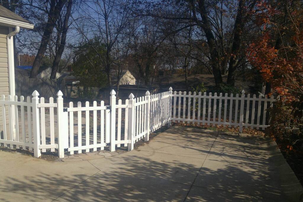 Fenced in back yard with flagstone patio.