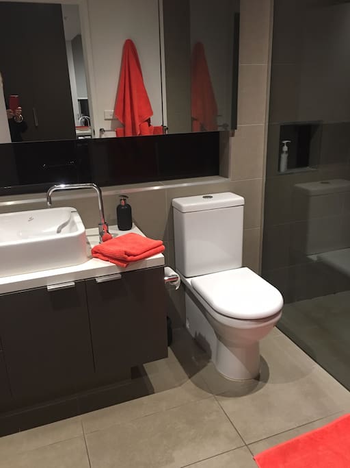 Clean modern bathroom washing machine in cupboard