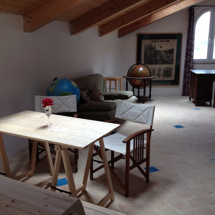 Room with an Ikea sofà bed and a kitchenette hidden in a closet.