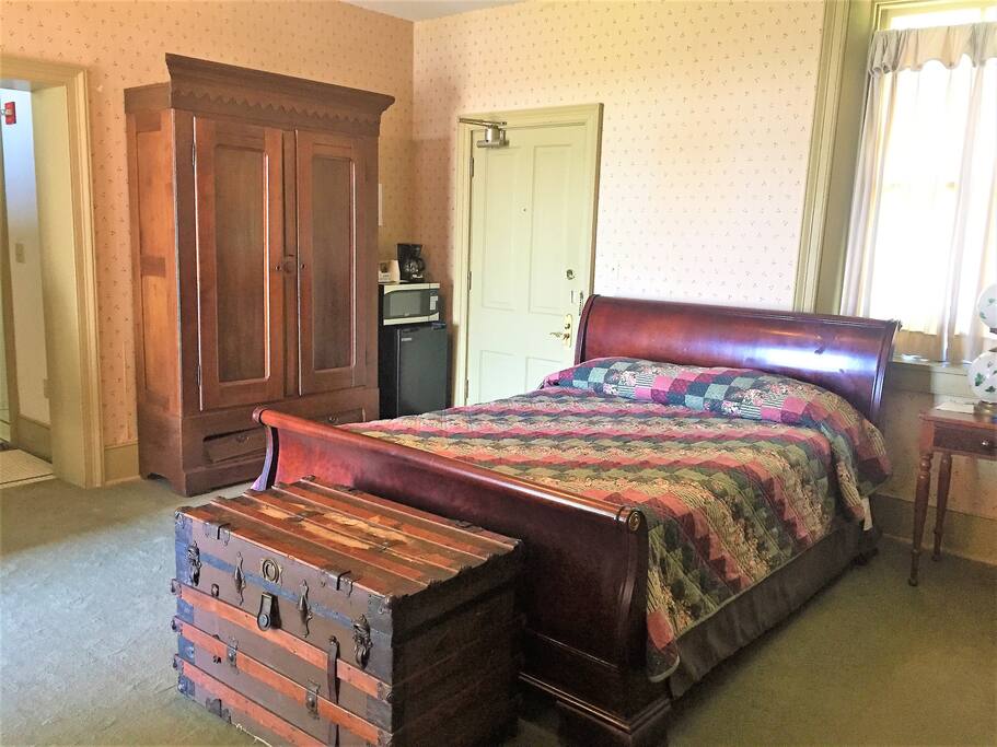 Queen size bed with microwave, coffee pot & refrigerator