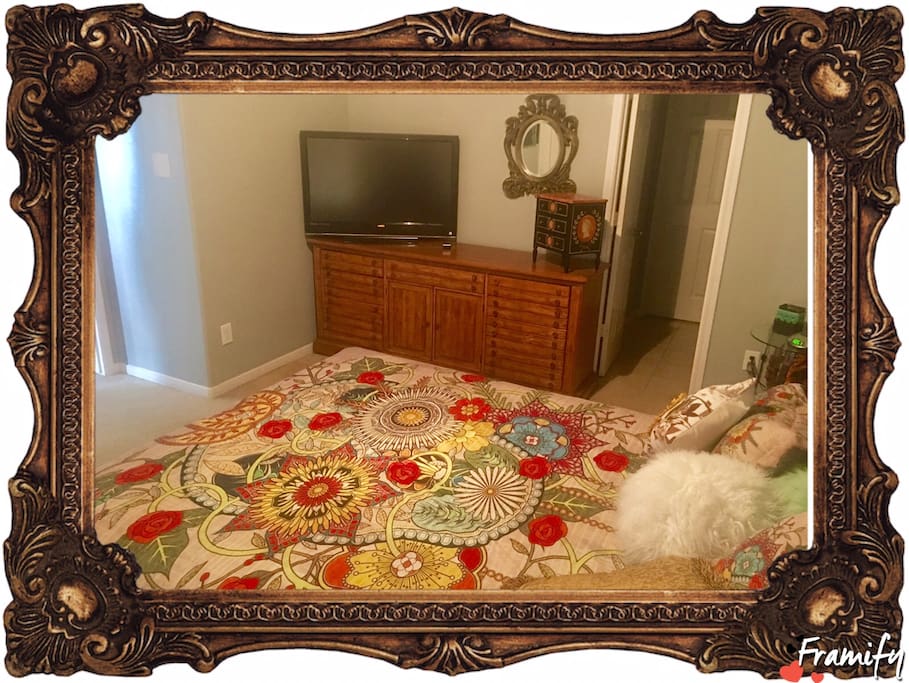 Bedroom with TV and empty antique dresser