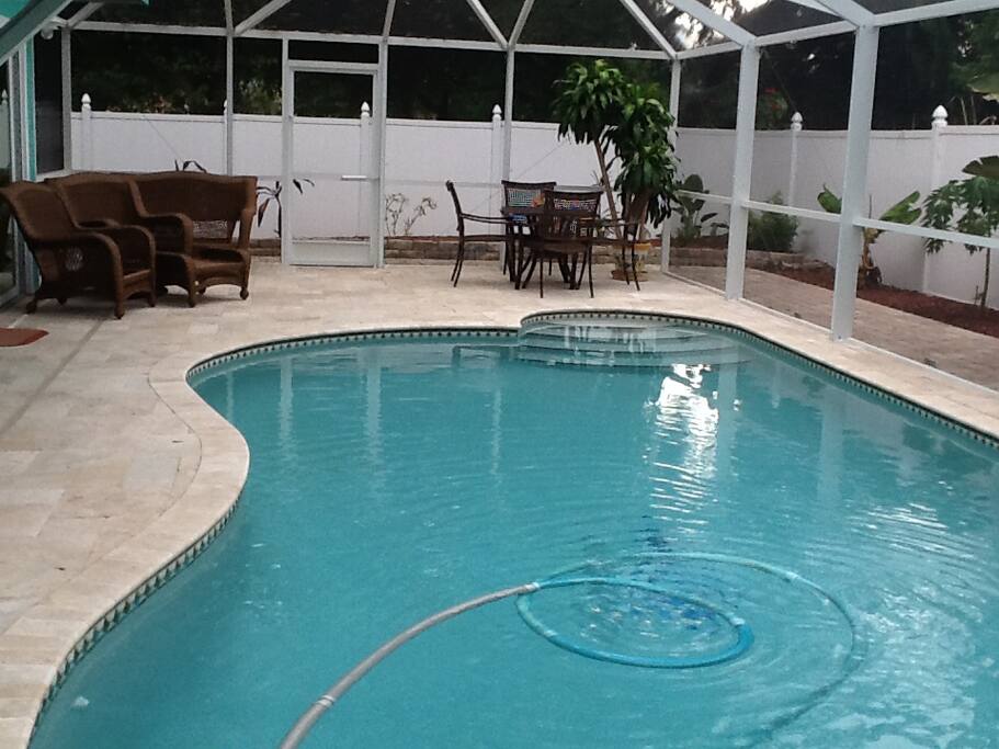 Heated pool,lounge chairs , and table and chairs