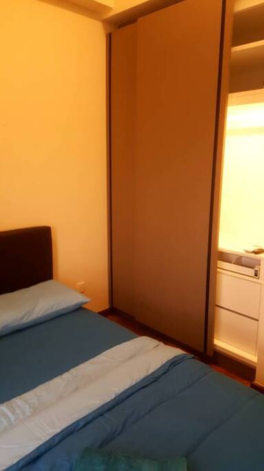 Spacious wardrobe with dressing table features. Clothes hangers are provided.