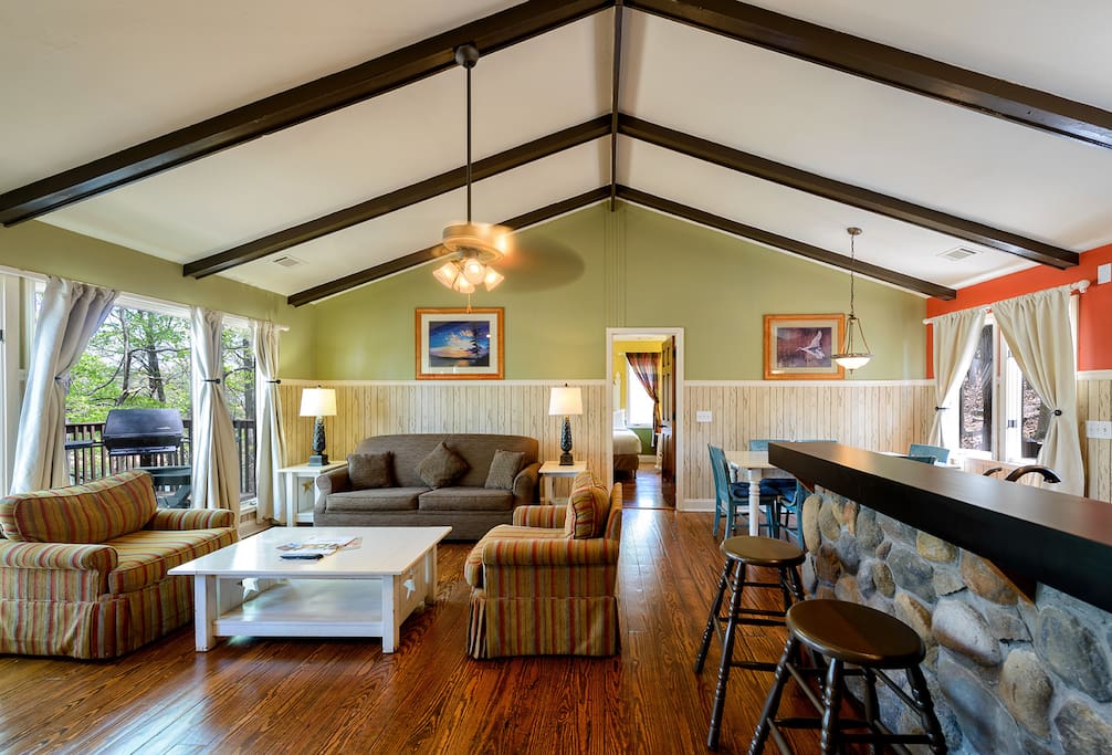 The spacious living room has seating for four on the couches, and six at kitchen table.