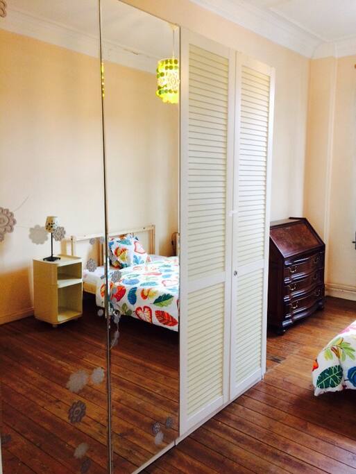I front the bedroom there's a big wardrobe with a mirror