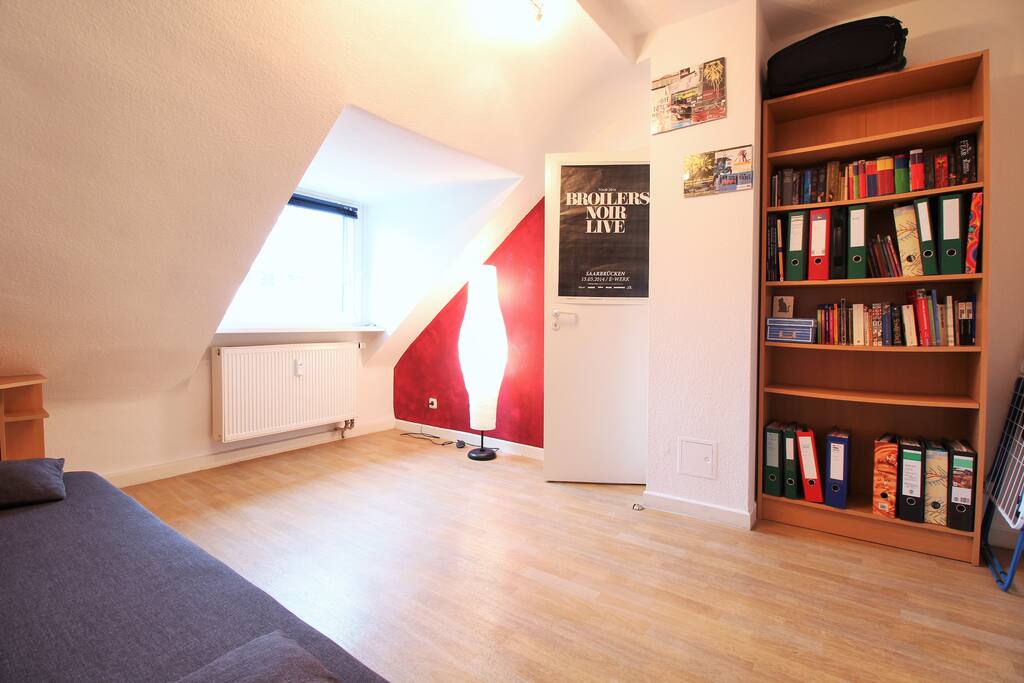 The window allows the light to brighten up the room.