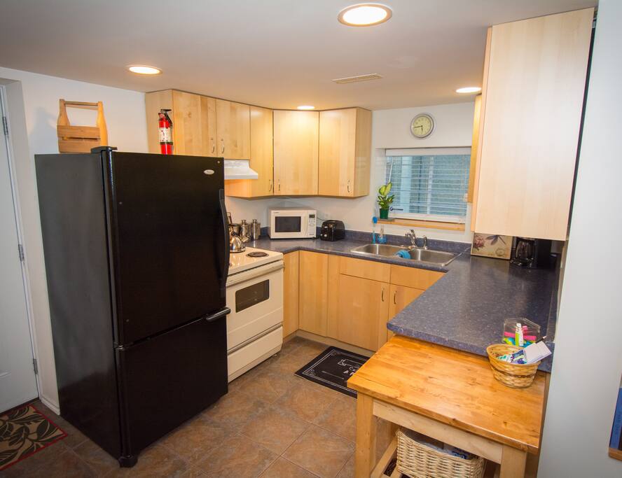 Kitchen with fridge, stove, microwave, toaster and coffee maker