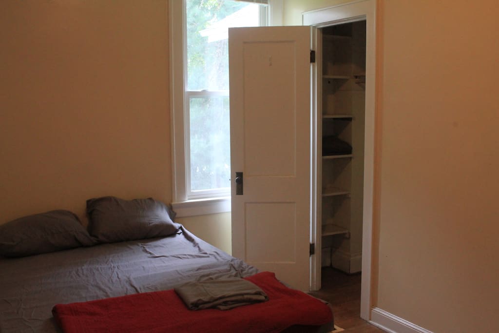 closet with shelves, towel, and hangers