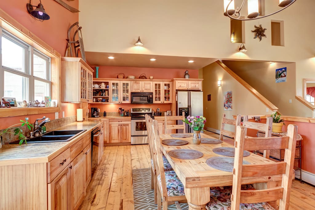 Open entertaining kitchen with one of two dining tables. Overall sitting for 14 people