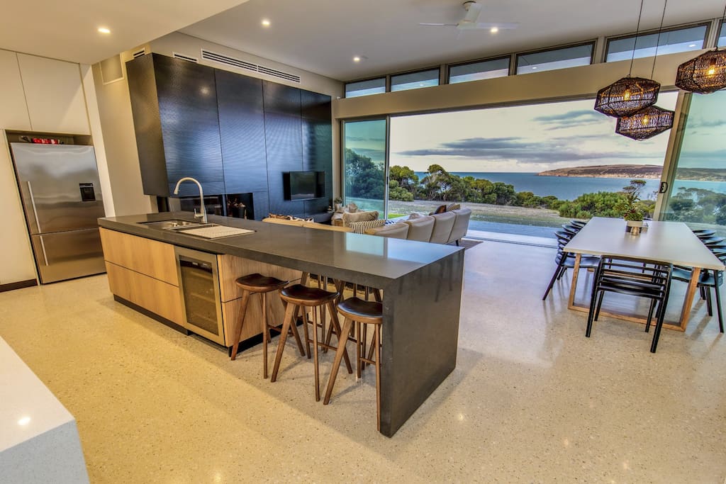 Kitchen with bar fridge, microwave, gas cooktop, fridge with plumbed water and ice machine