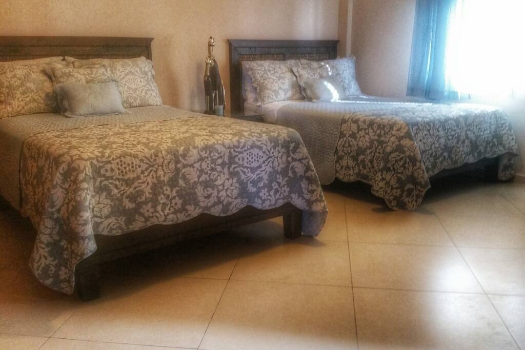 Spacious Bedroom with 2 double beds, Television, Air Condition and it's own gorgeous big bathroom with Jacuzzi bath/shower, and lots of closet space with hangers.