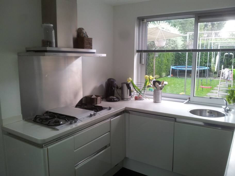 kitchen with microwave and oven and two sinks