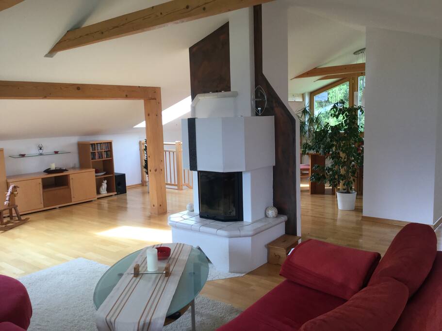 Wohnzimmer mit offenen Kamin der eine einzigartige Wohnatmosphäre schafft.
Living room with open fireplace creating a unique living atmosphere