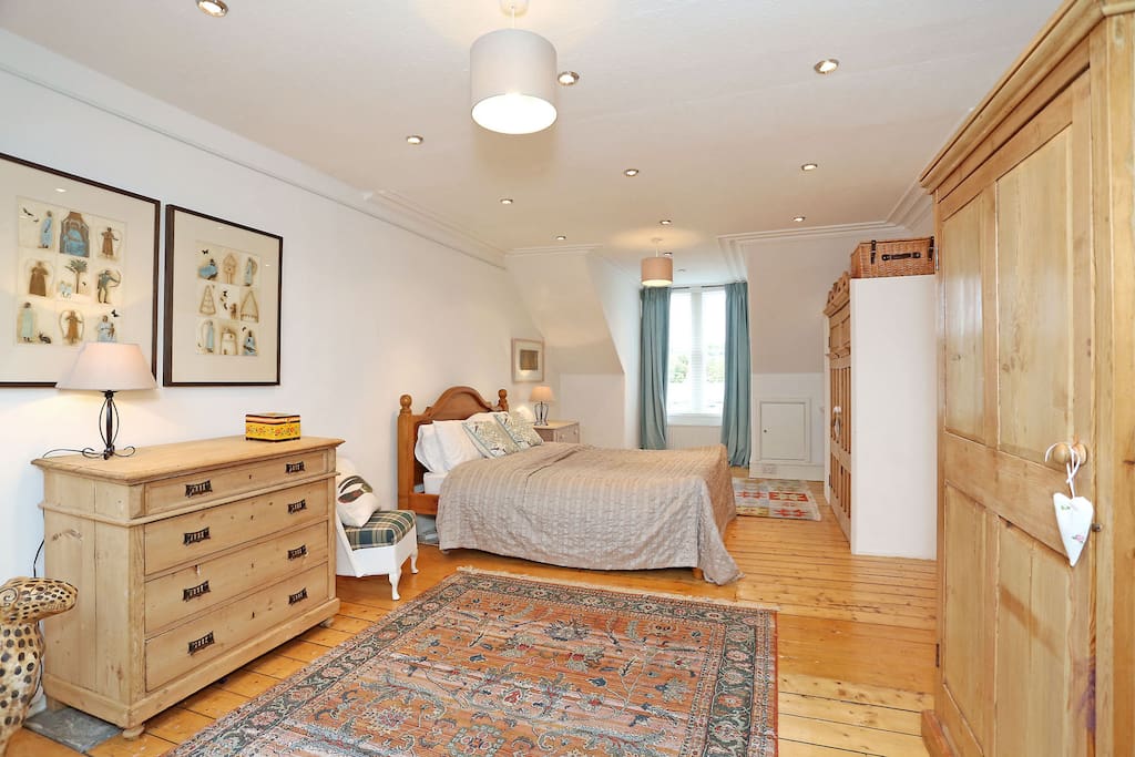 Large Bedroom with King Size Bed and Antique Furniture.