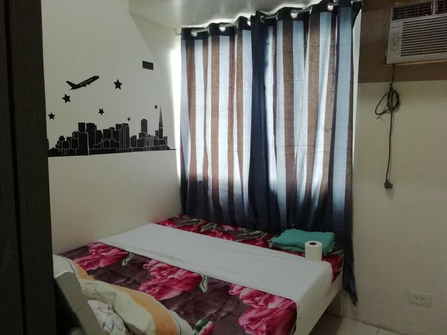 Queensized bed facing city view