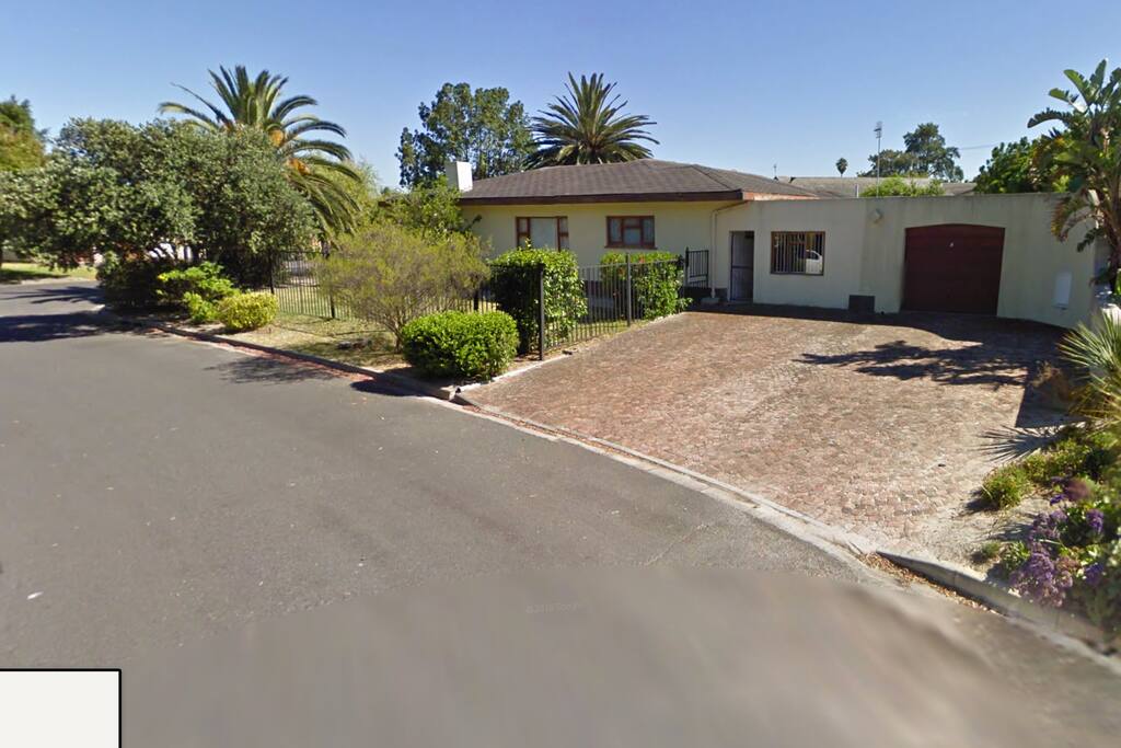 Back section showing back garage, driveway and side entrance.