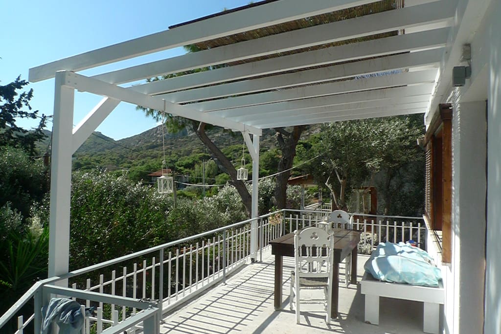front balcony island style with pergola and bamboo olive trees are all around this summer setting quit in nature you can enjoy a relaxing breakfast or a lunch after swim.