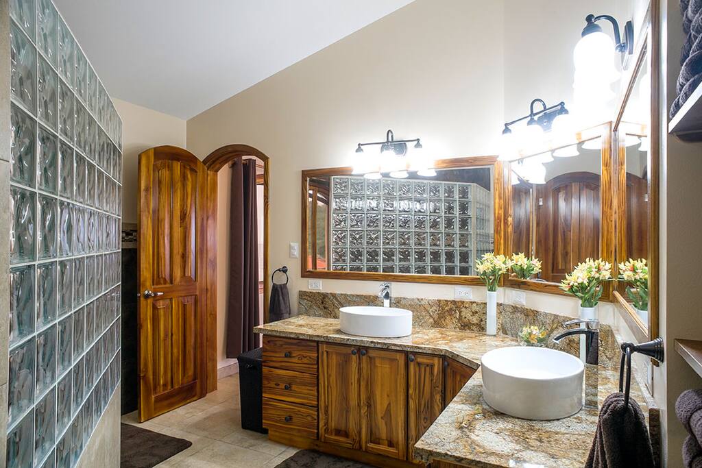 En-suite bathroom - 12’ teak vanity with granite top, double sinks and triple mirrors.