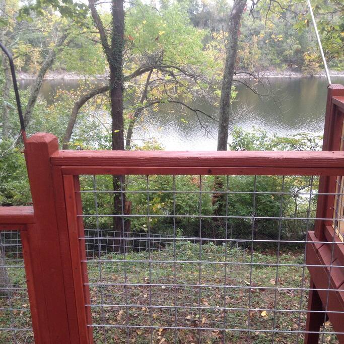 Back of Cottage standing on deck overlooking lake. There are stone steps and hand rail to lake. Marina is six tenths of a mile away.